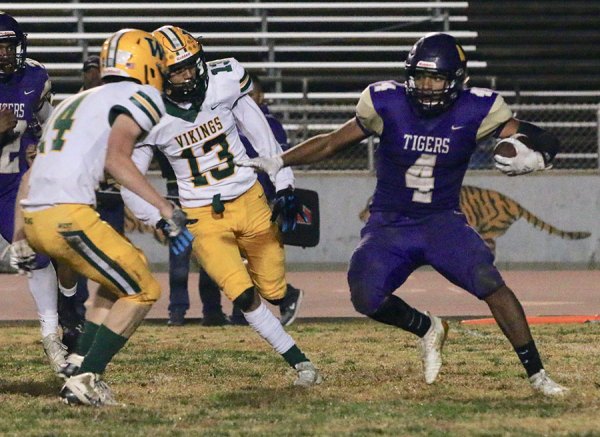 Lemoore's Elijah Jones (No. 4) runs for short yardage in the second quarter of Friday's playoff game against West Bakersfield High School.
